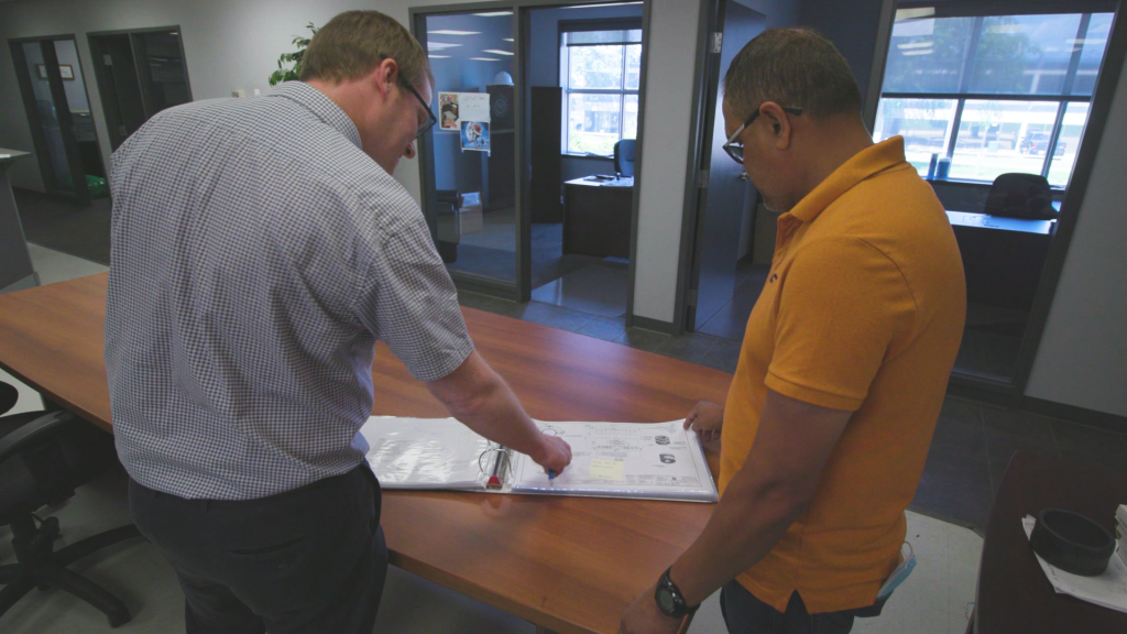 Workers viewing documents and plans in an office space